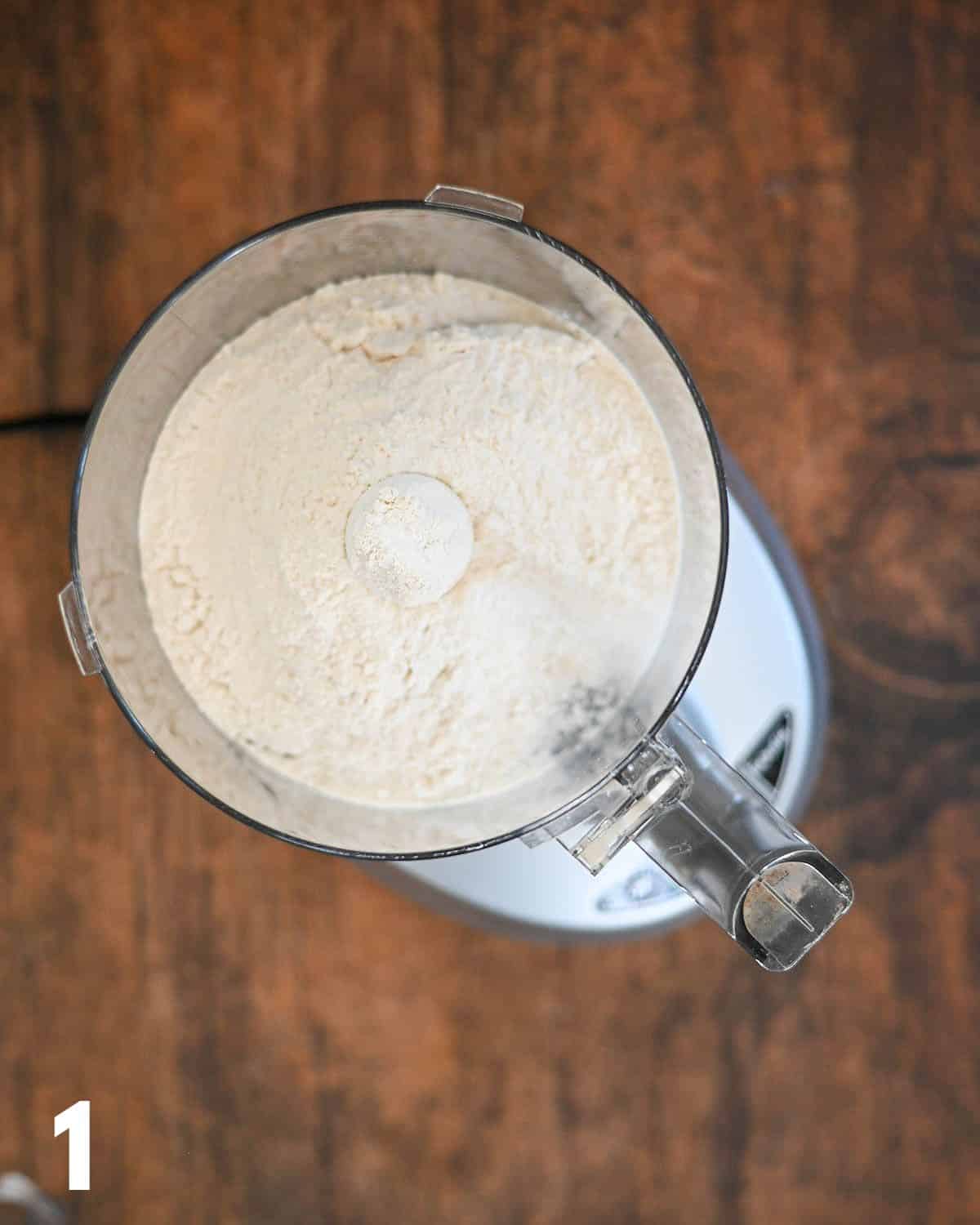 Flour, salt, and baking powder in a food processor bowl. 