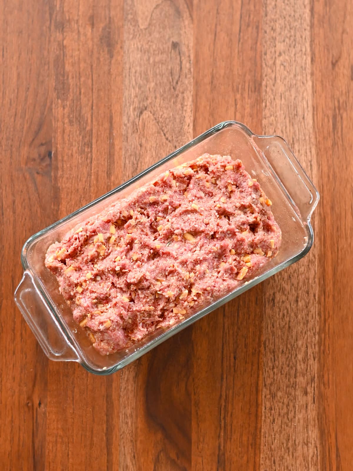 Raw meatloaf in a baking dish. 