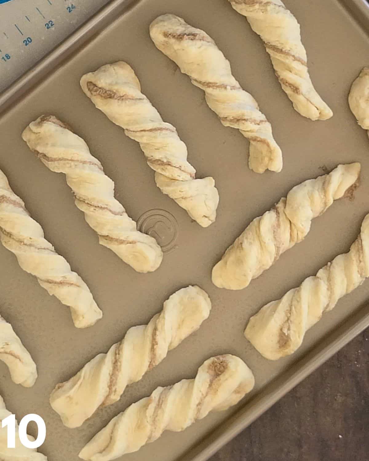 Cinnamon twists on a baking sheet ready to bake. 