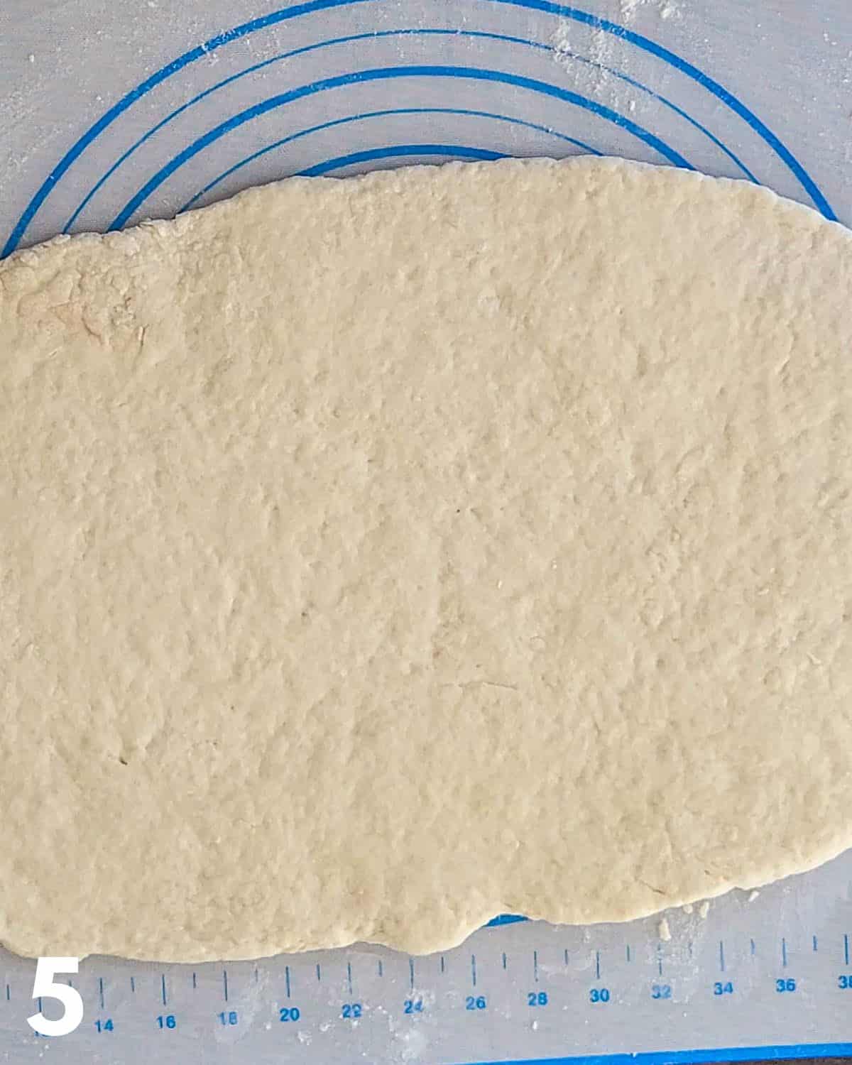 Dough rolled out on a pastry mat. 