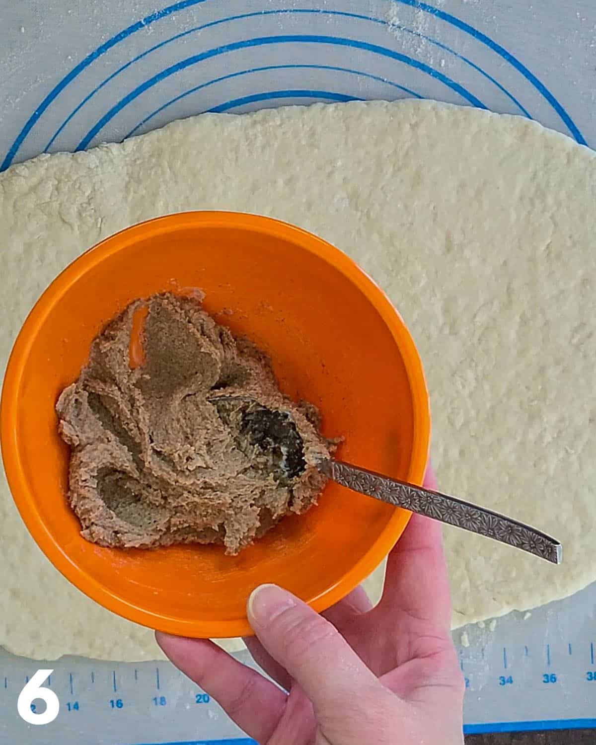 Brown sugar and cinnamon mixture in an orange bowl. 