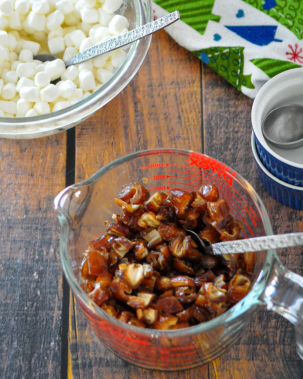chopped dates in a measuring cup and marshmallows in a glass bowl. 