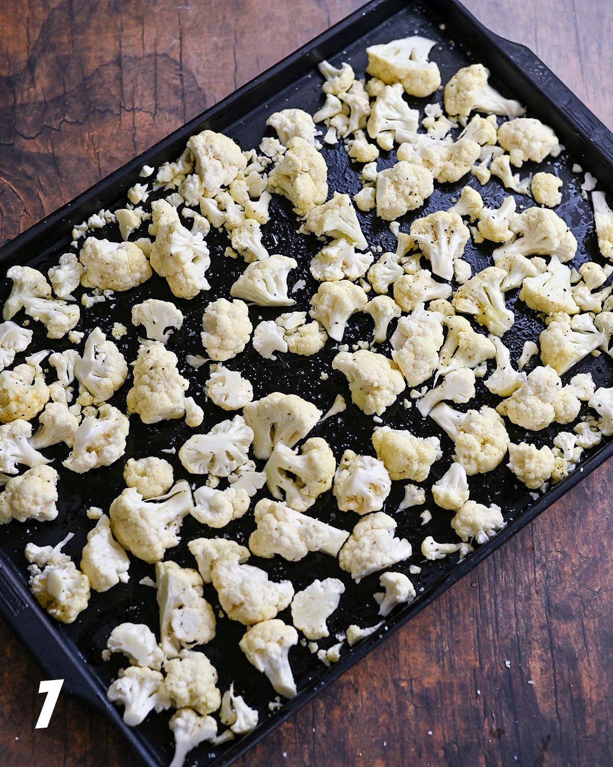 Cauliflower on a baking sheet ready for the oven.
