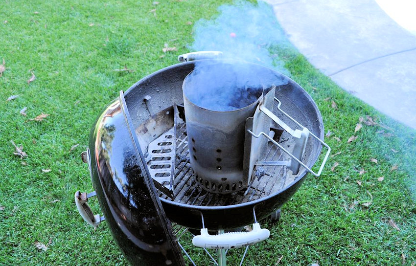 a smoking chimney sitting on a Weber bbq