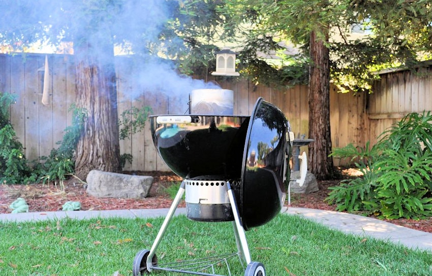 a Weber bbq in our yard with redwood trees in the background