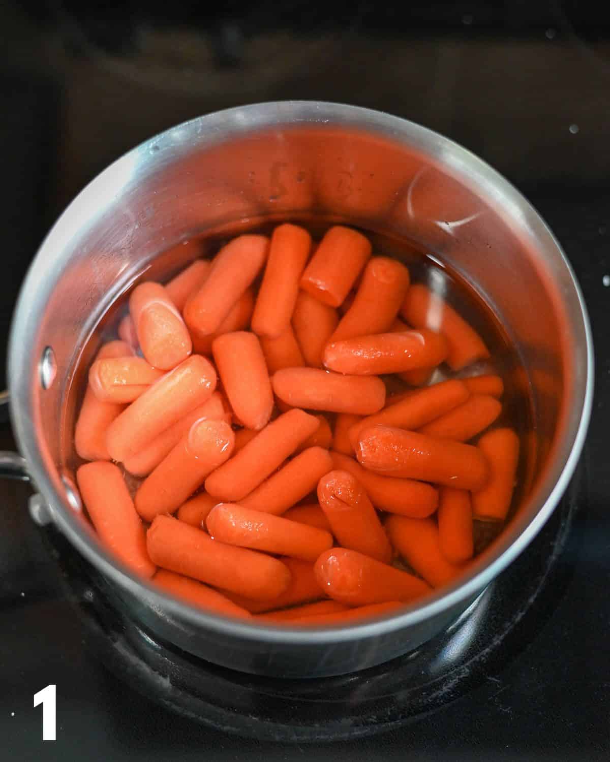 Carrots in a sauce pan with water. 