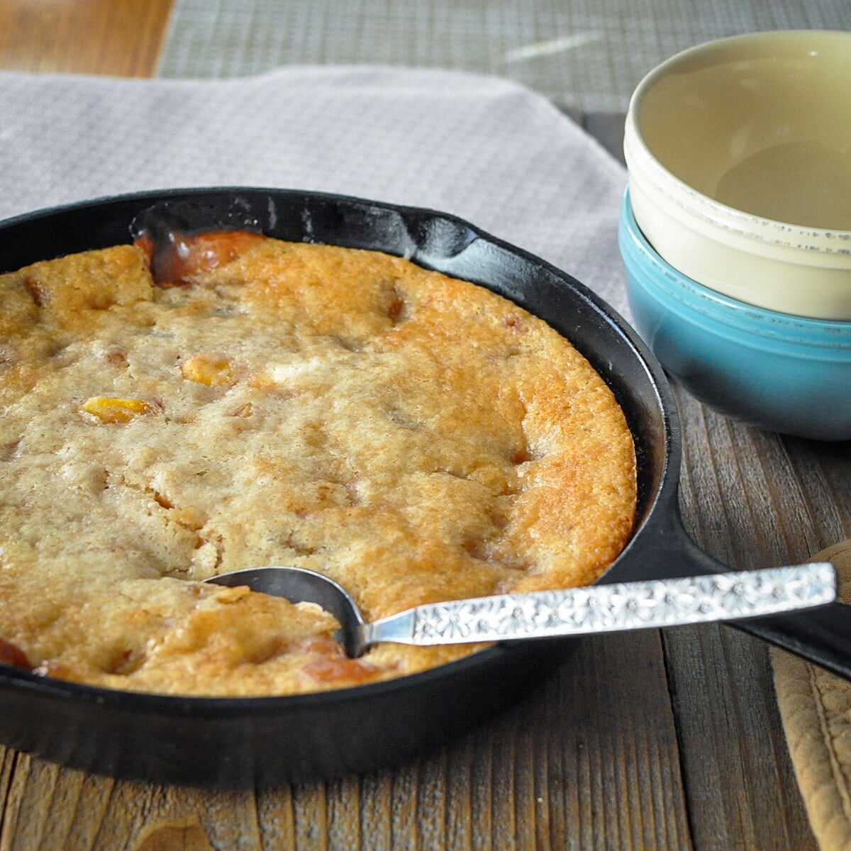 just baked peach cobbler in a cast-iron skillet