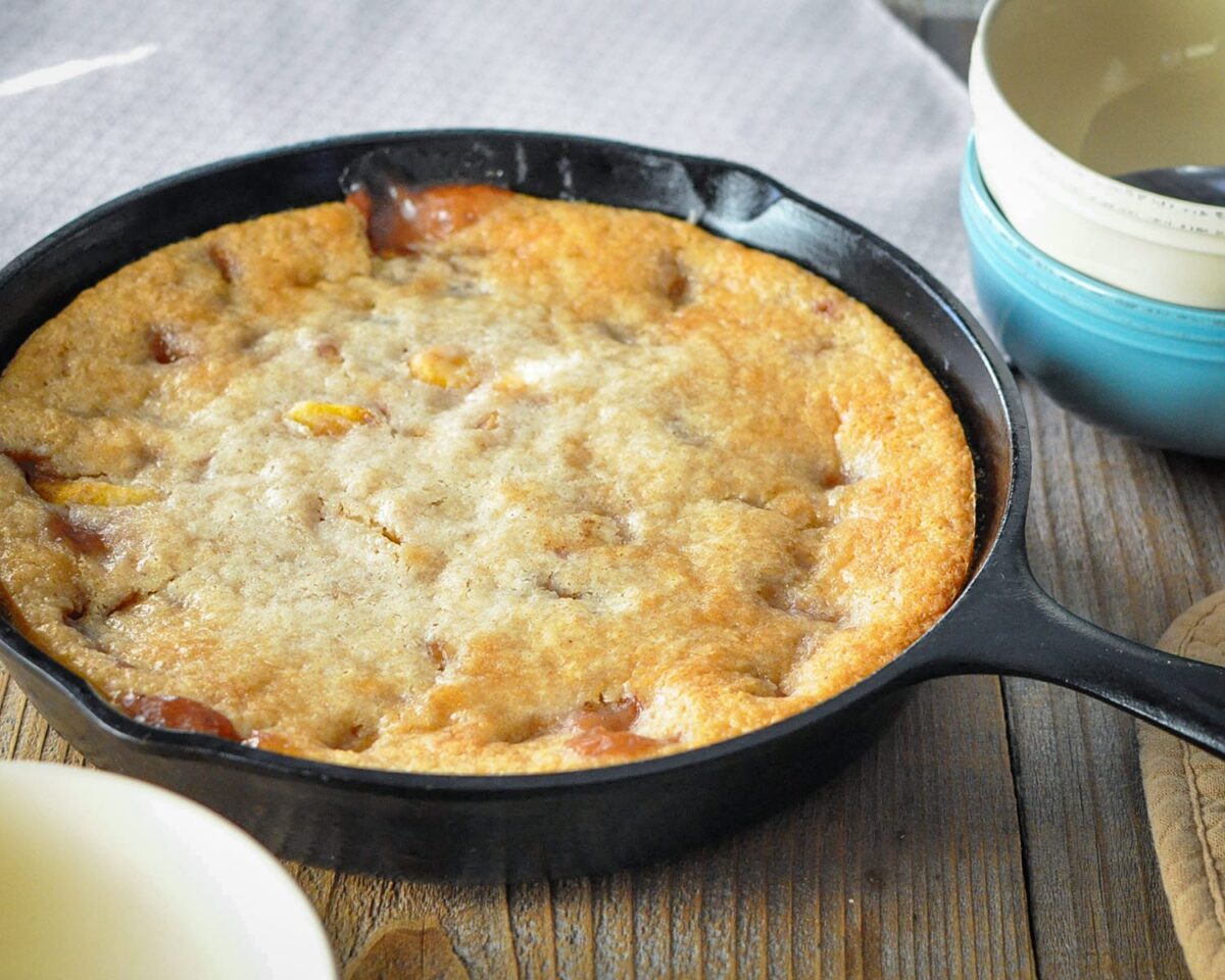 fresh baked cobbler in a cast iron skillet ready to serve