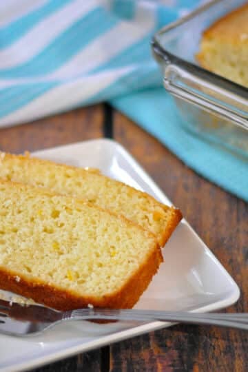 Sliced lemon bread on a white plate with a fork.