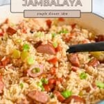 Close-up of Smoked Sausage Jambalaya in a pot, featuring tender rice, smoked sausage, colorful veggies, and a serving spoon.