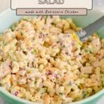 A bowl of chicken macaroni salad with diced vegetables and tender pieces of Rotisserie Chicken Macaroni Salad, accompanied by a serving spoon and the recipe title above.