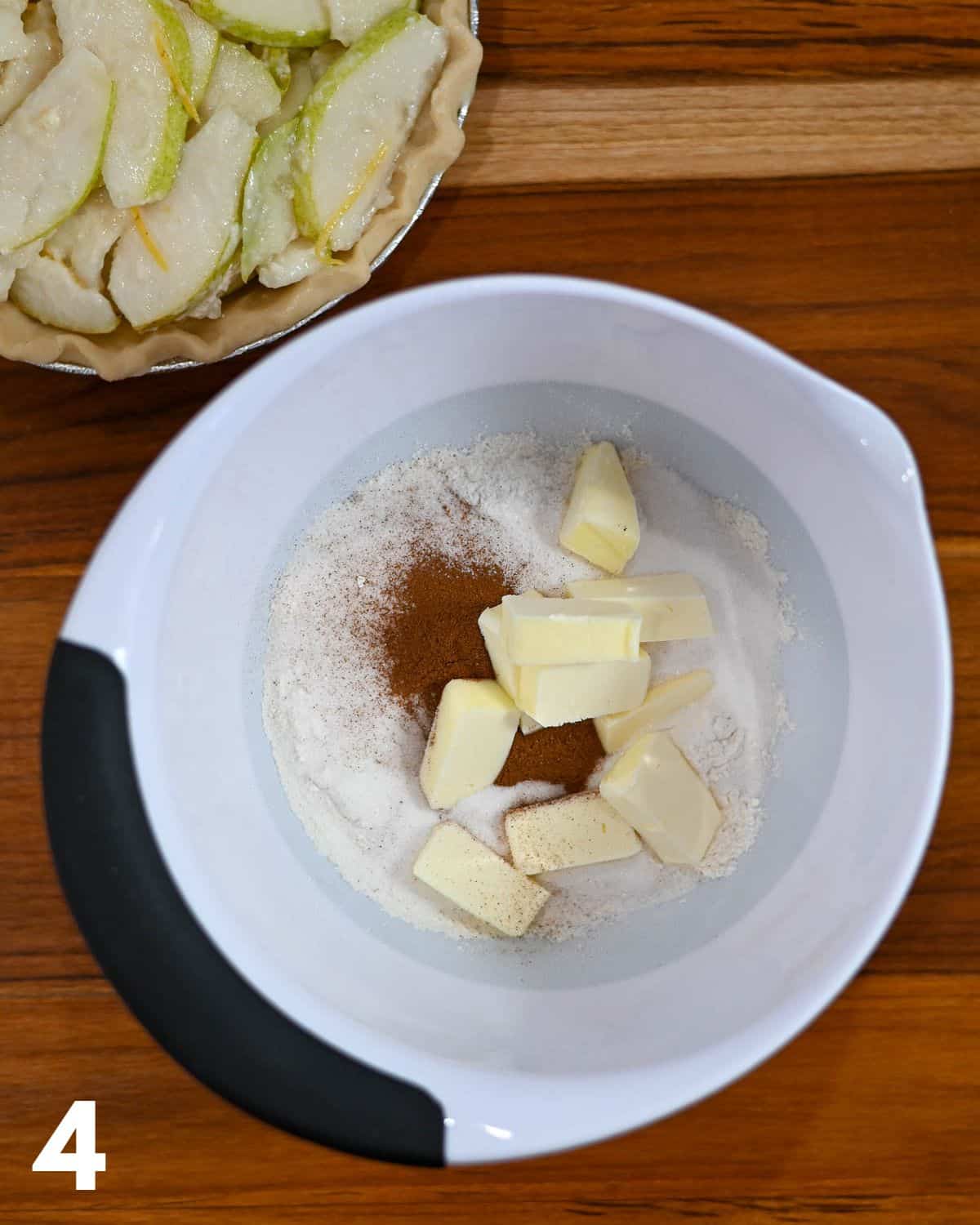 Butter, flour, sugar, and cinnamon in a mixing bowl. 