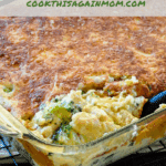 Close up photo of a scoop of chicken divan being removed from a 13 x 9 baking dish