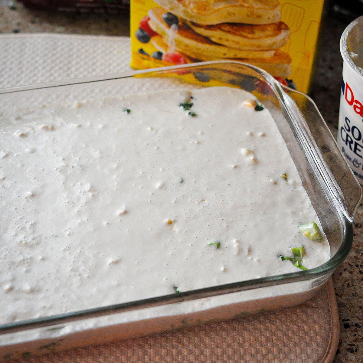 a chicken and broccoli casserole with a biscuit topping ready to bake. 