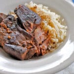 pork ribs in a white bowl with a side of rice