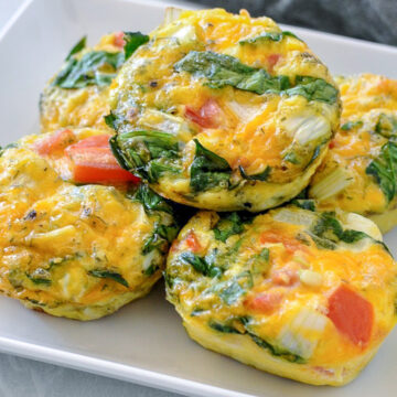 spinach egg cups on a white plate