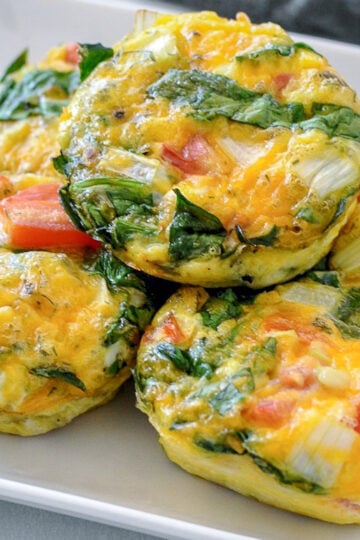 spinach egg cups on a white plate