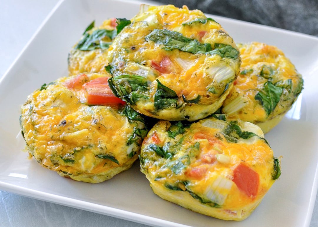 spinach egg cups on a white plate
