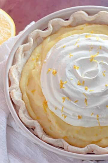 A creamy lemon pie with whipped topping.