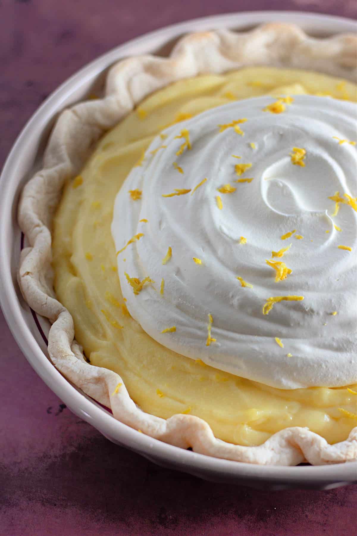 A creamy lemon pie with whipped topping.