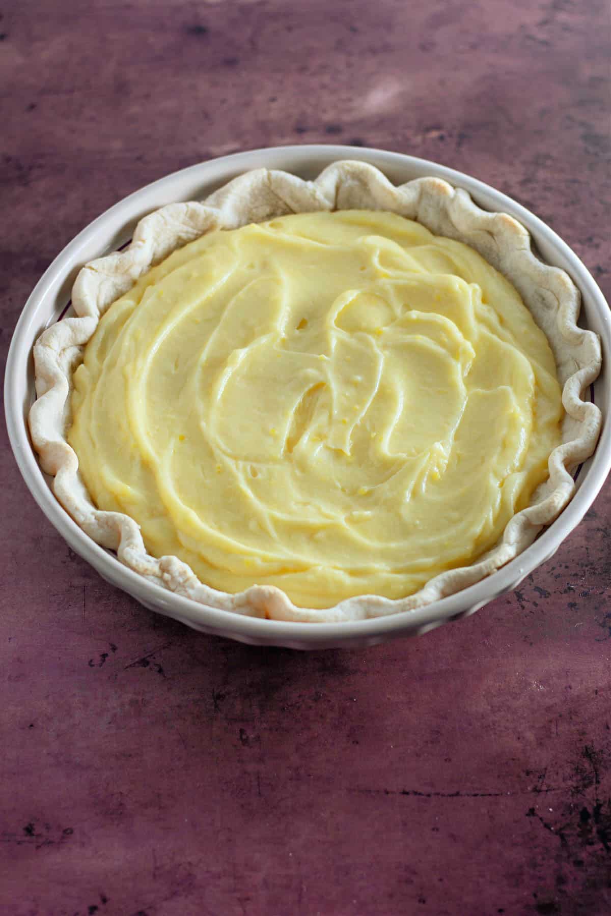 Creamy lemon pie filling in a baked pie shell. 