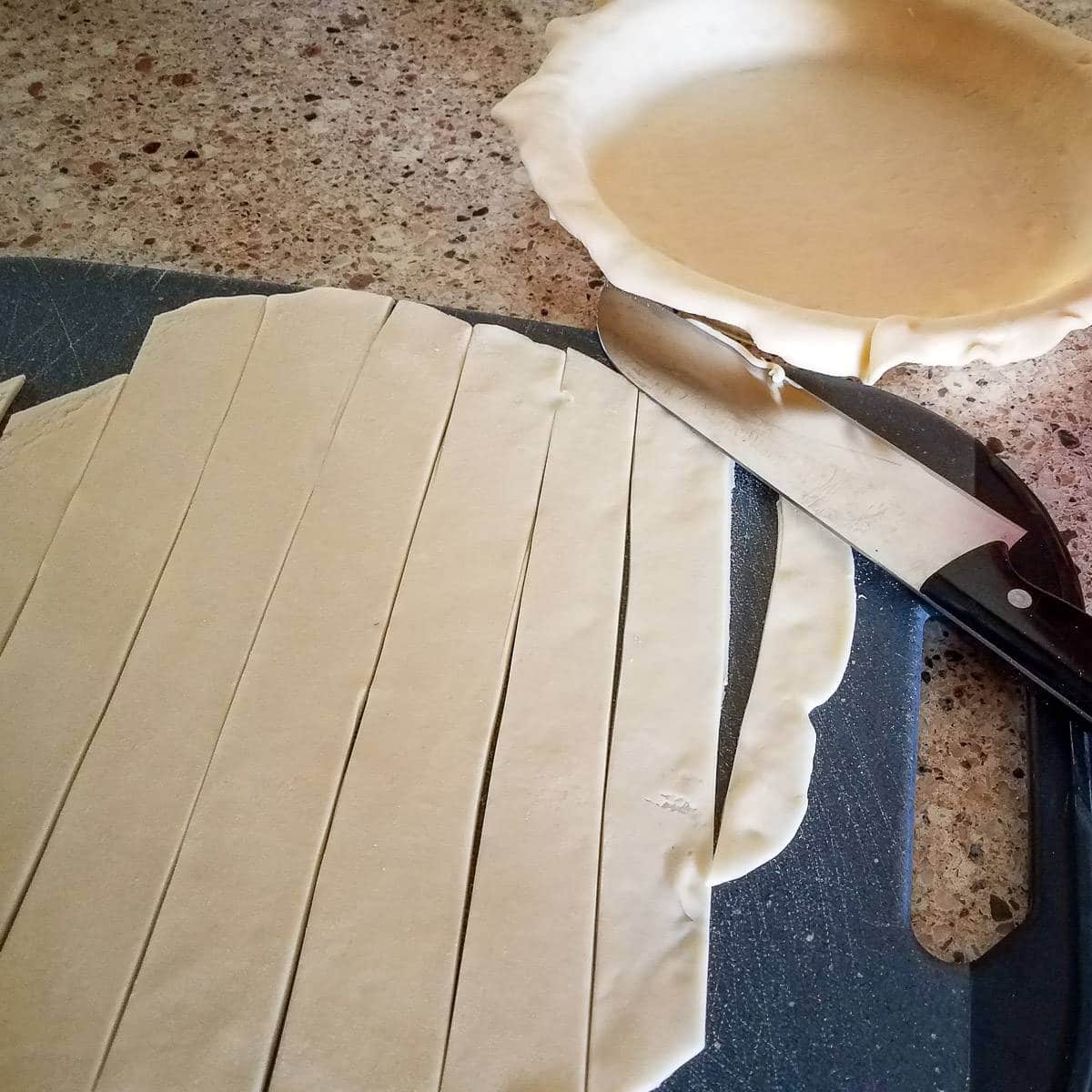lattice crust being cut for apricot pie
