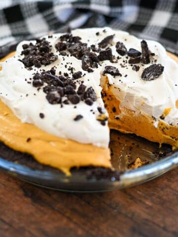 Pumpkin no bake cheese pie with one slice missing.