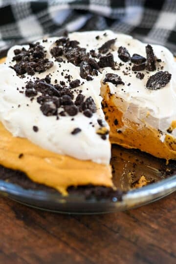 Pumpkin no bake cheese pie with one slice missing.
