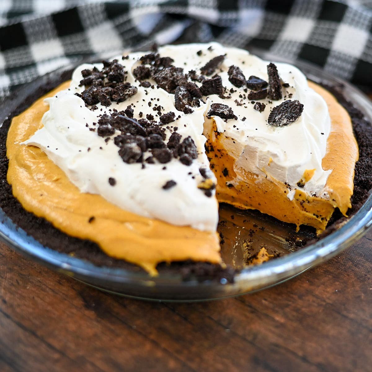 Pumpkin no bake cheese pie with one slice missing. 