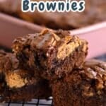 Three Nutter Butter Chocolate Chip Brownies stacked on a cooling rack, with more nutter butter brownies in a pink baking dish behind.