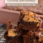 Three peanut butter cookie brownies stacked on a cooling rack, with a baking pan in the background—these delectable Nutter Butter Chocolate Chip Brownies are the ultimate treat for nutter butter lovers.