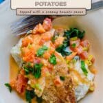 Tilapia with a Creamy Tomato Sauce served on bacon mashed potatoes and fresh spinach, garnished with herbs.