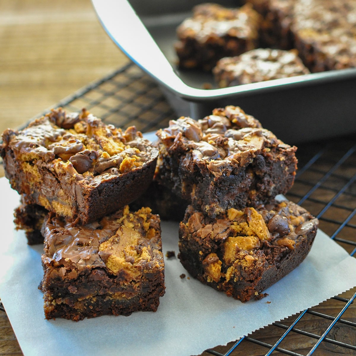 a stack of brownies made with nutter butter cookies on a piece of parchment