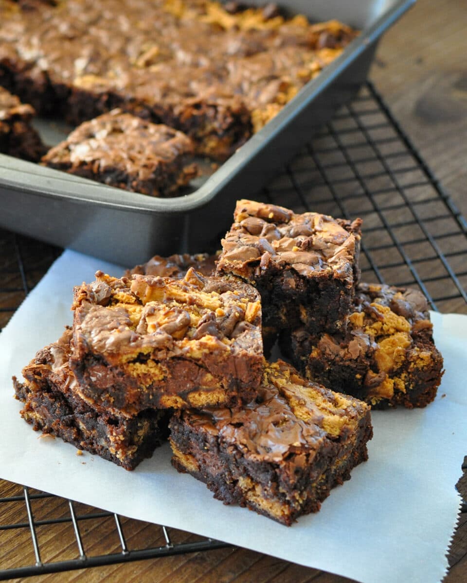 a stack of brownies made with nutter butter cookies on a piece of parchment