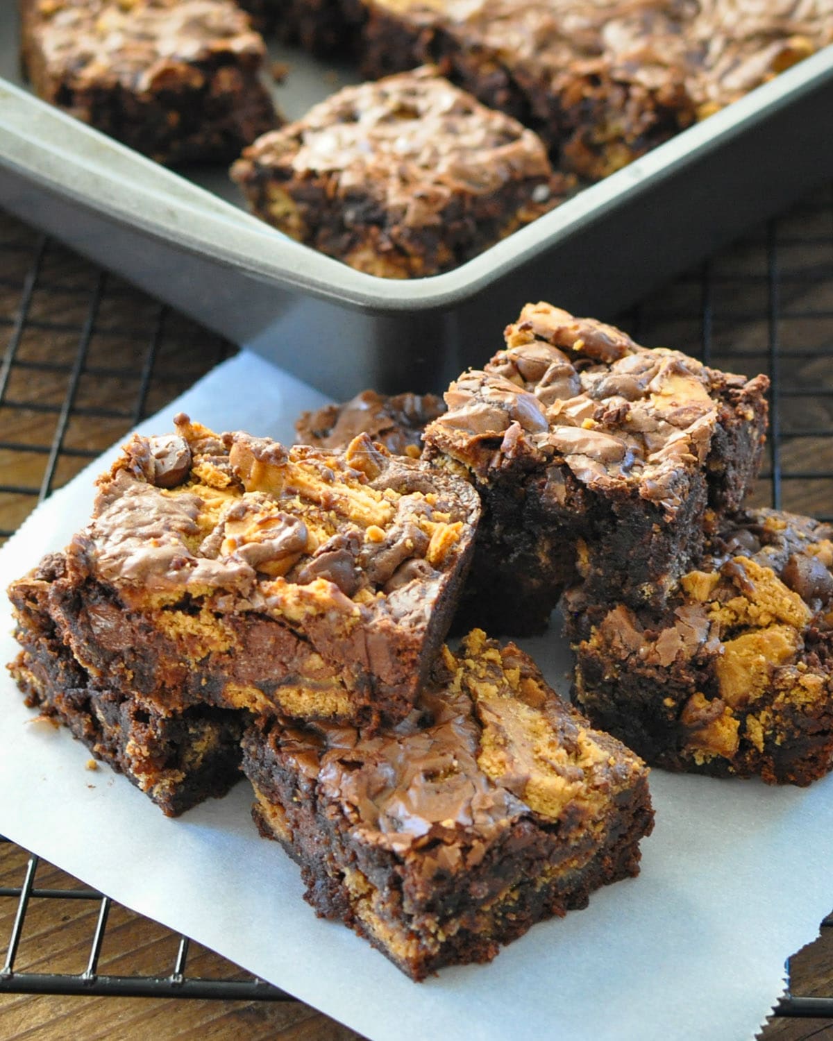 a stack of brownies made with nutter butter cookies on a piece of parchment