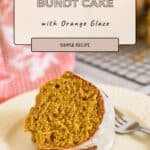 A slice of Pumpkin Bundt Cake with orange glaze sits on a plate, topped with a drizzle of white icing.