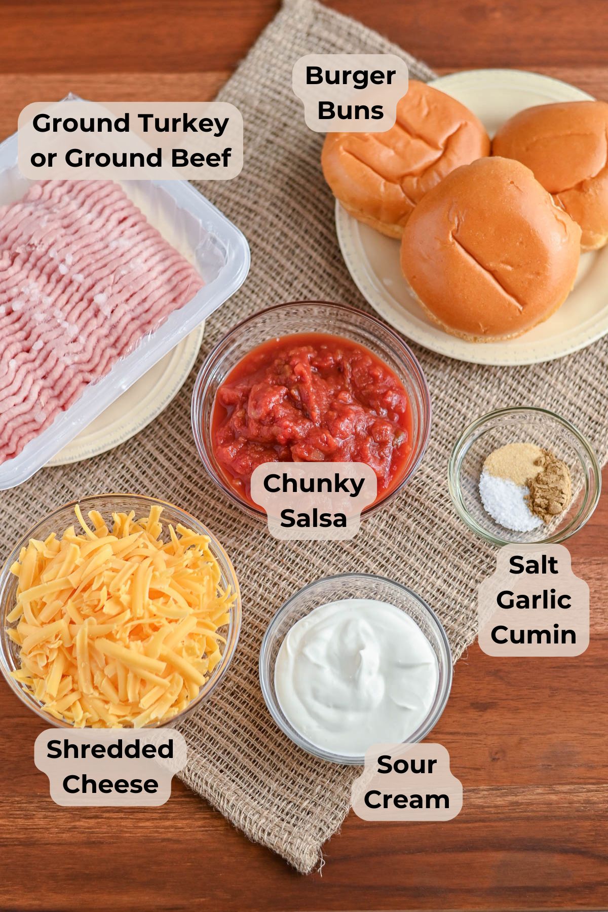 Ingredients for burgers: ground turkey, burger buns, chunky salsa, shredded cheese, sour cream, and spices-perfect for Taco Sloppy Joes or other creative recipes.