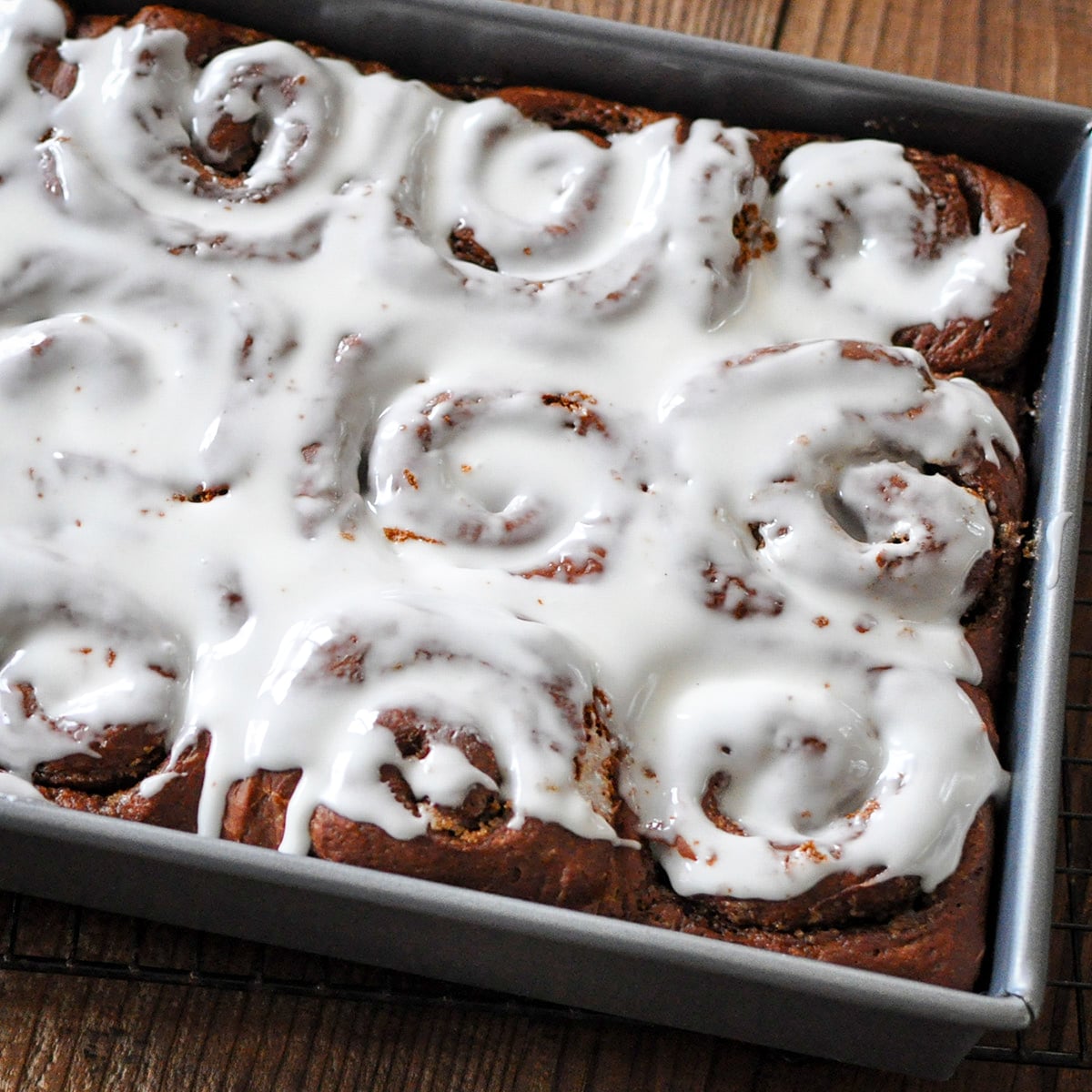 just baked cinnamon rolls covered in icing