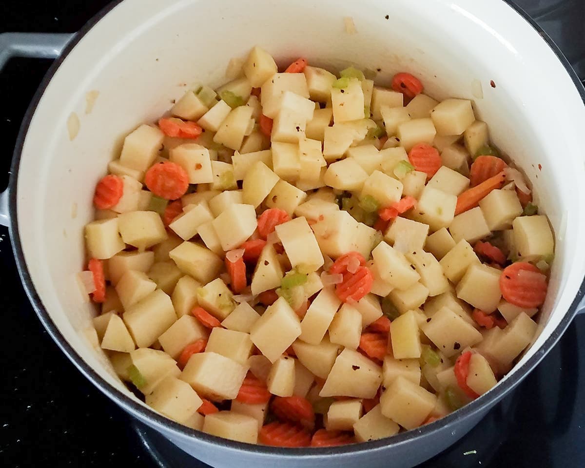 potatoes, carrots, onion, celery, cooking in a stock pot