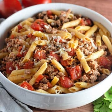 Seasoned ground turkey and pasta in a white bowl.