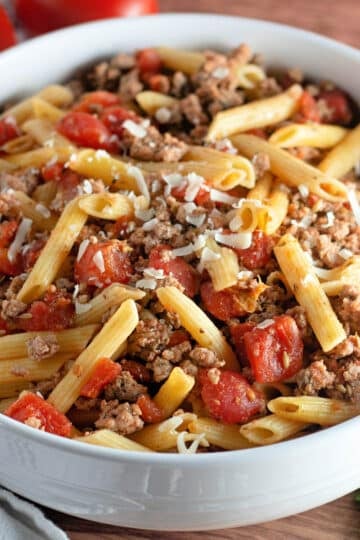 Seasoned ground turkey and pasta in a white bowl.