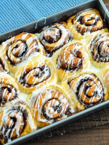 just baked cinnamon rolls drizzled with glaze