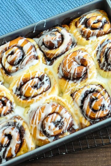 just baked cinnamon rolls drizzled with glaze