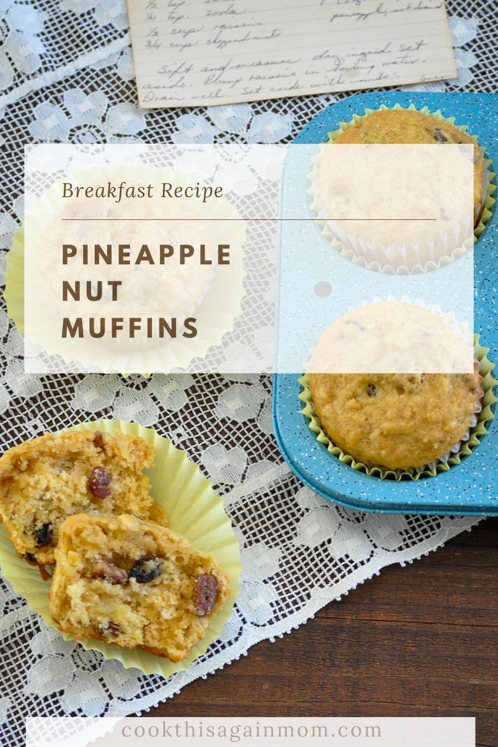 a pineapple muffin split in two laying on a lace table runner next to the pan of muffins and recipe card