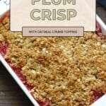 A delicious plum oatmeal crisp, this baked plum dessert features a sweet fruit filling and an oatmeal crumb topping, served in a white dish on a wooden table.