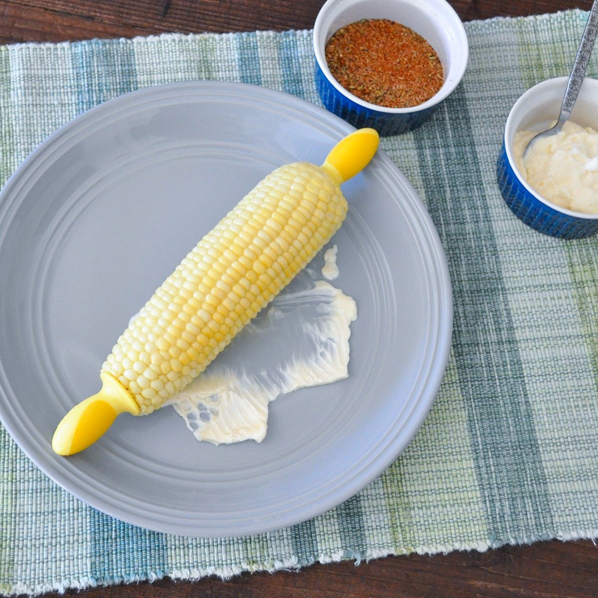 corn and butter on a gray plate