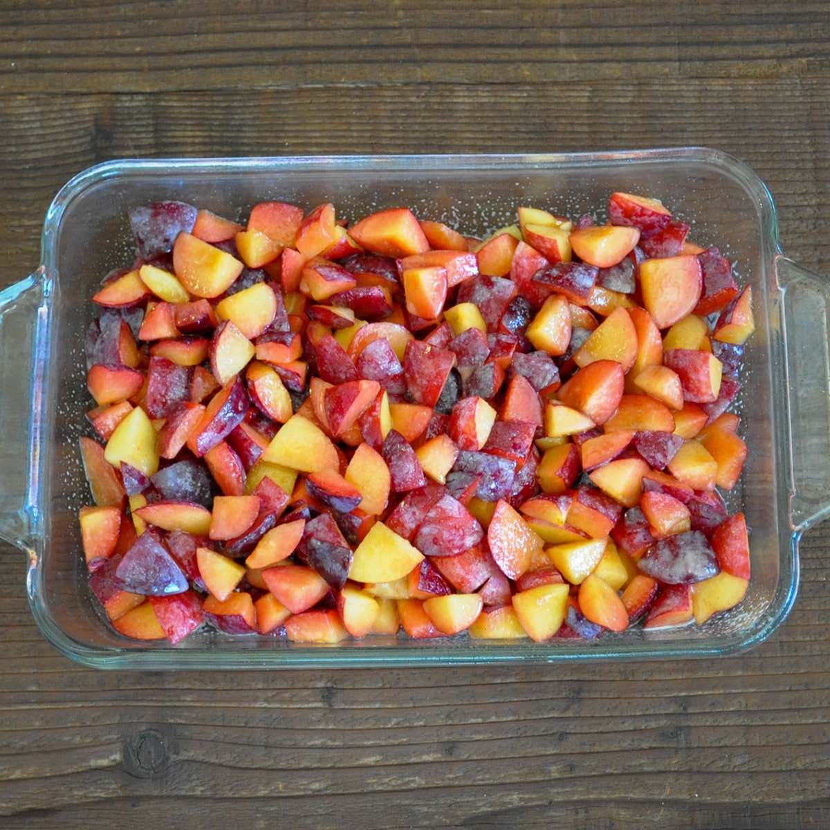 diced plums coated with sugar in a baking dish