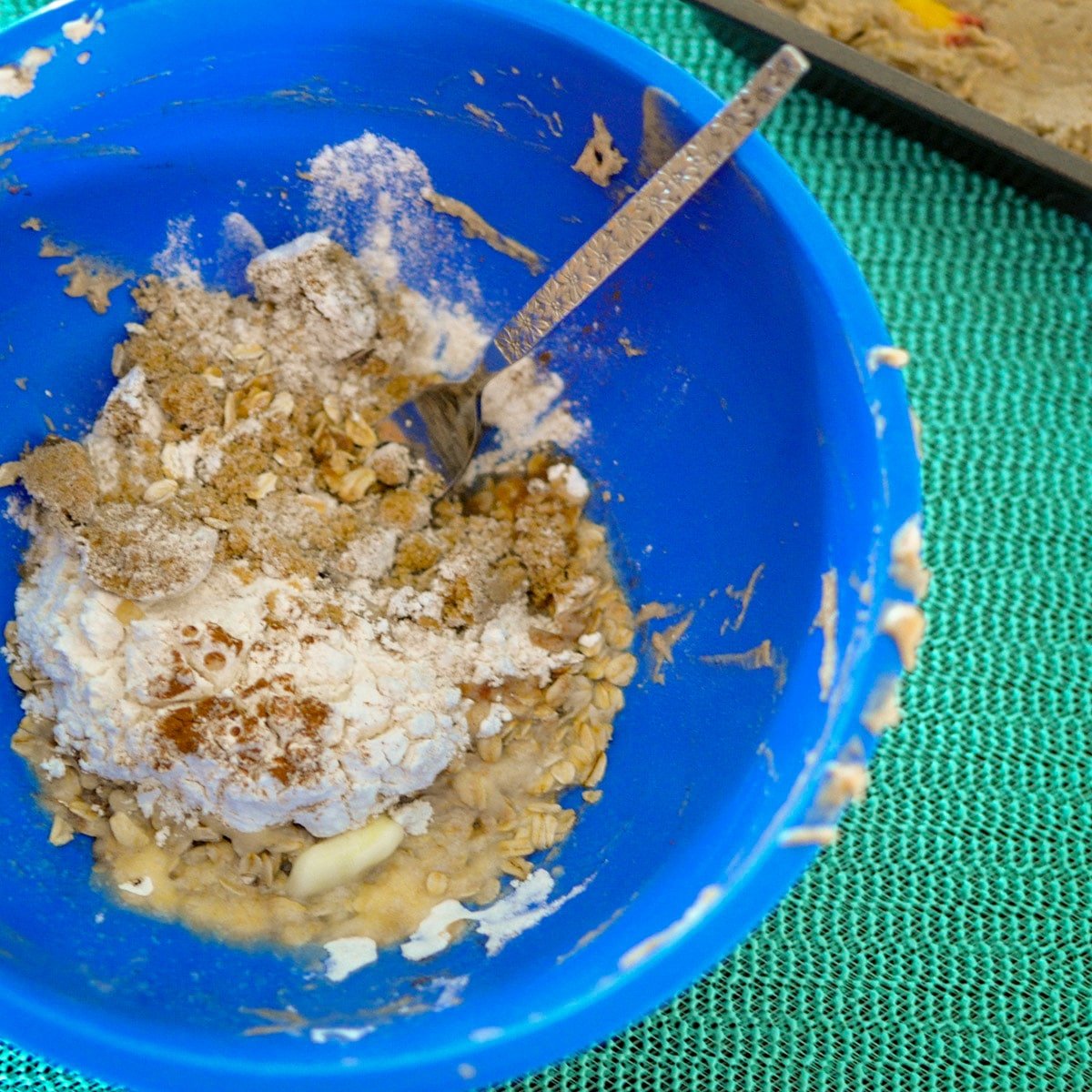 brown sugar, flour, oats, cinnamon, butter in a blue bowl