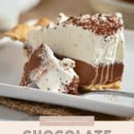 A slice of Chocolate Tofu Pie topped with whipped cream and chocolate shavings on a white plate, showcasing a delicious plant-based dessert recipe.