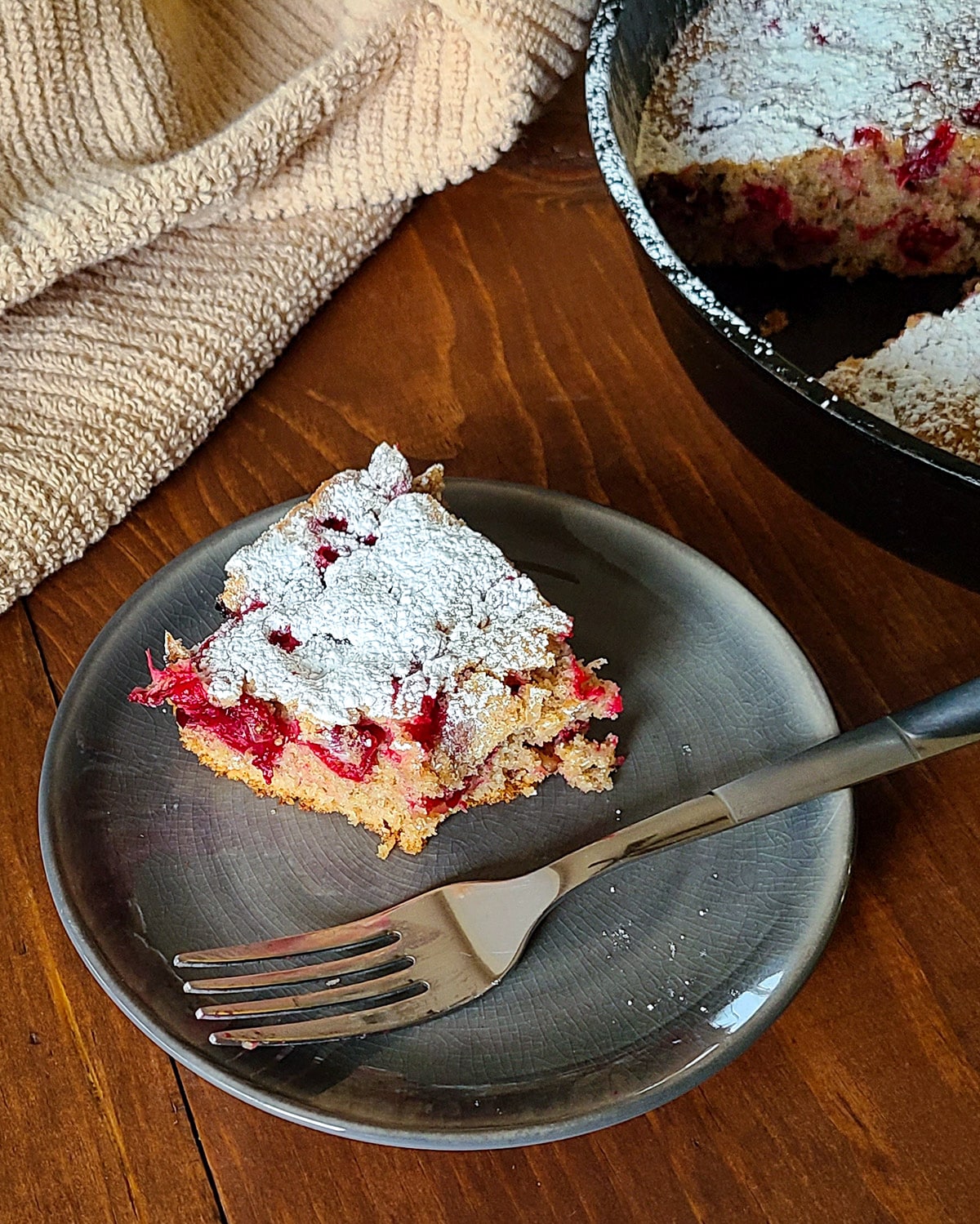 a half eaten piece of cranberry cake on a plate